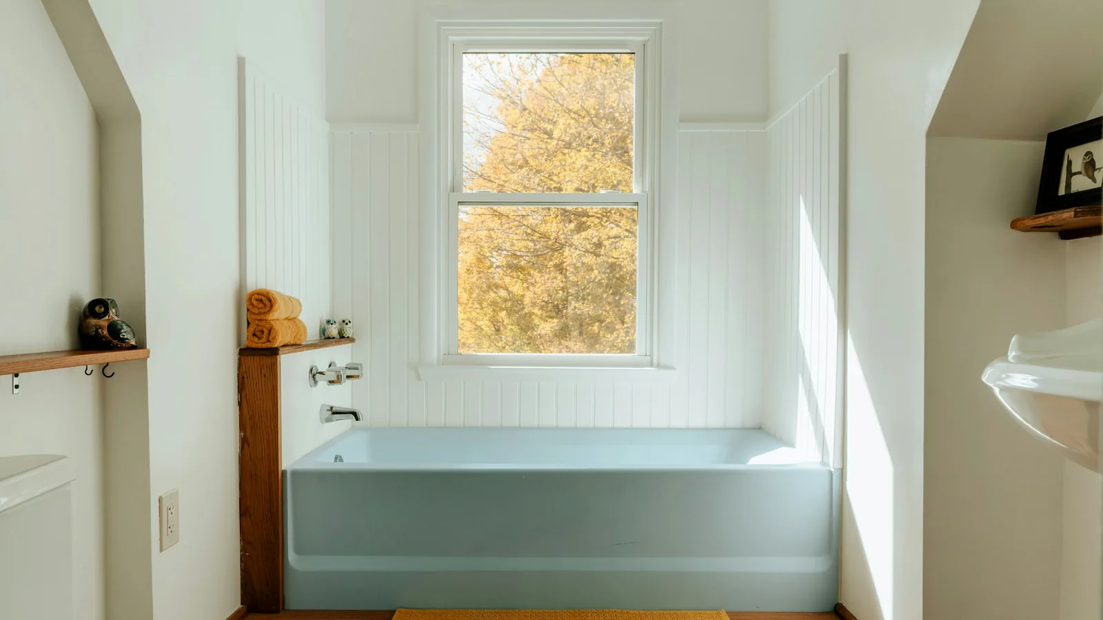 A bright bathroom with a bathtub and a window