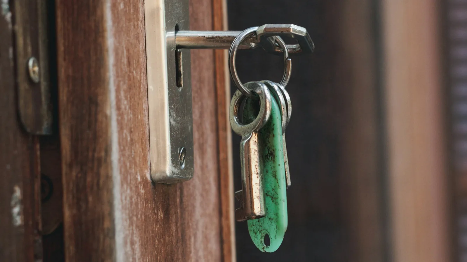 Keys hanging from a lock in a wooden door
