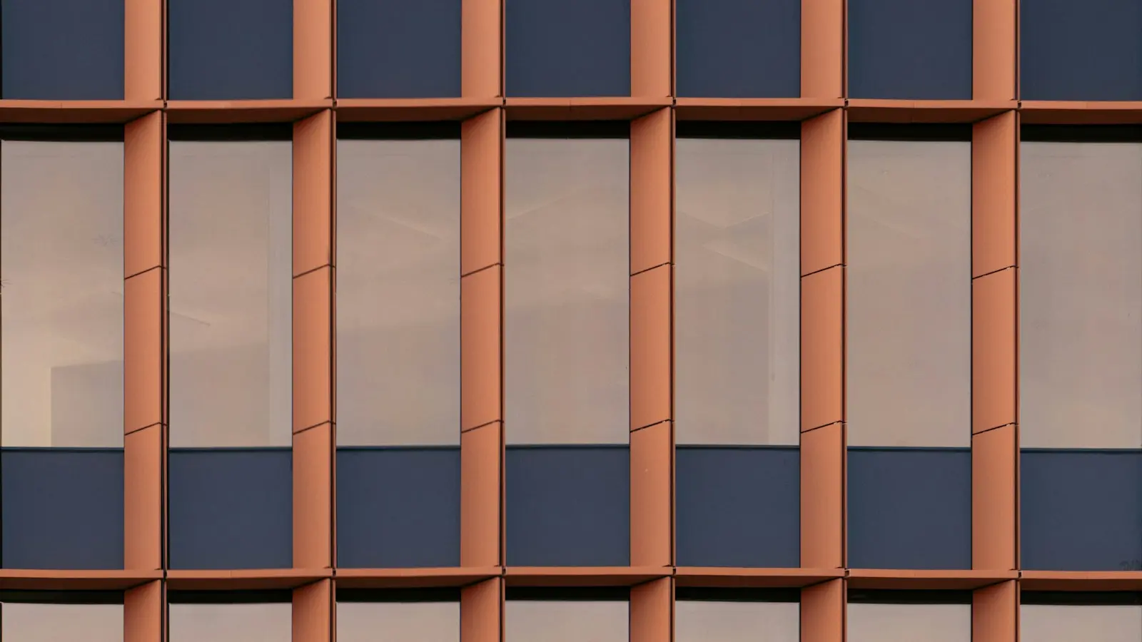 Building facade divided into a repeating grid of framed windows
