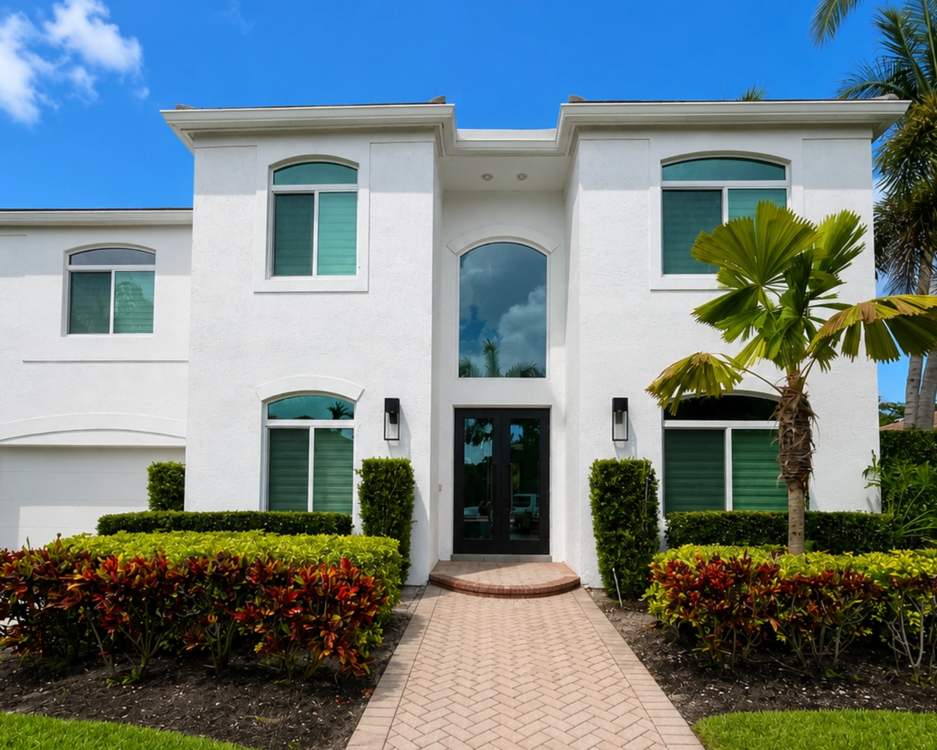 Bronze-frame impact windows installed on a home in Miami Springs